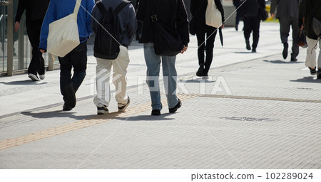 Figures of people walking in the downtown area Figures of people walking in the downtown area 102289024