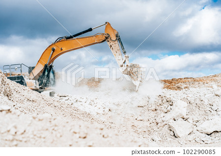 Wheel loader, large bucket with limestone. Construction. Open pit mining quarry Wheel loader, large bucket with limestone. Construction. Open pit mining quarry 102290085
