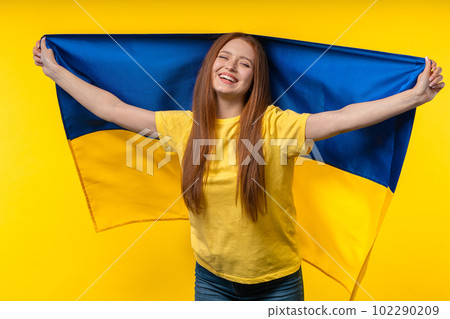 Happy woman with national Ukrainian flag on yellow. Ukraine, patriot, victory Happy woman with national Ukrainian flag on yellow. Ukraine, patriot, victory 102290209