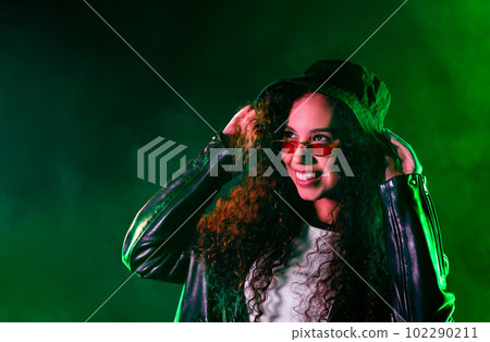 Pretty woman in green neon light. Smoky background, night party, disco club. Pretty woman in green neon light. Smoky background, night party, disco club. 102290211