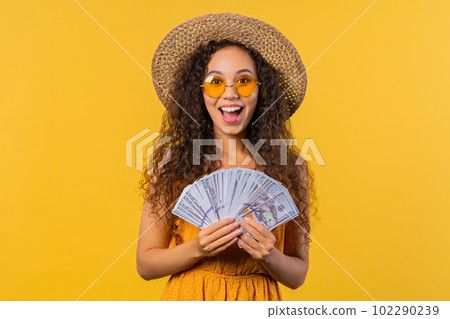 Rich excited curly haired woman with cash money - USD currency dollars banknotes Rich excited curly haired woman with cash money - USD currency dollars banknotes 102290239