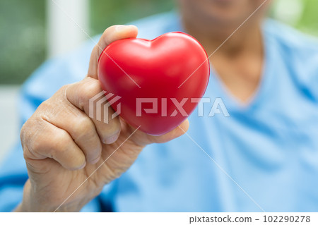 Doctor holding a red heart in hospital, healthy strong medical concept. Doctor holding a red heart in hospital, healthy strong medical concept. 102290278
