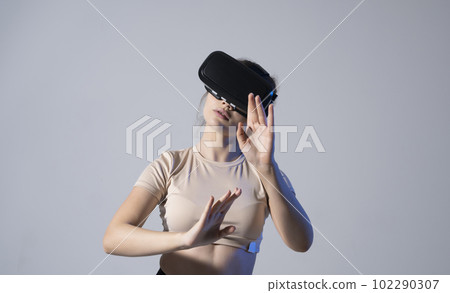 Female engineer wearing virtual reality headset designing a new pruducts or technologis using VR technology. Development and prototyping software. Female engineer wearing virtual reality headset designing a new pruducts or technologis using VR technology. Development and prototyping software. 102290307