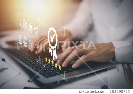 Quality assurance of business services, Businessman Hand shows the sign of the top service Quality assurance in Black background , Guarantee, Standards, ISO certification and standardization concept. 102290735