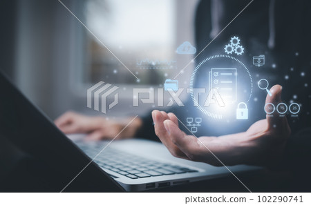 Businessman working on laptop with virtual screen. Online documentation database, IT consultant being set up Virtual Document Management System with laptop,Software for archiving corporate files. Businessman working on laptop with virtual screen. Online documentation database, IT consultant being set up Virtual Document Management System with laptop,Software for archiving corporate files. 102290741