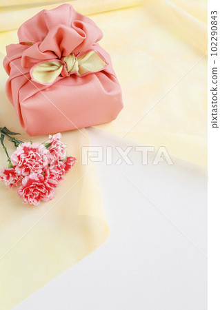 Gifts and flowers wrapped in a pink wrapping cloth Gifts and flowers wrapped in a pink wrapping cloth 102290843