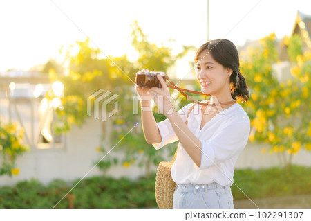 Portrait of asian woman traveler using camera at street of Bangkok, Thailand. Asia summer tourism vacation concept Portrait of asian woman traveler using camera at street of Bangkok, Thailand. Asia summer tourism vacation concept 102291307