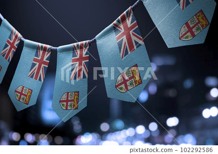 A garland of Fiji national flags on an abstract blurred background 102292586