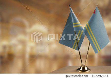 Small flags of the Aruba on an abstract blurry background 102292681