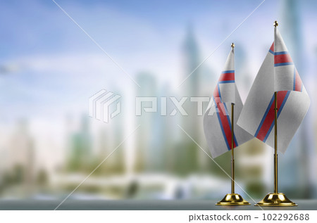 Small flags of the Faroe Islands on an abstract blurry background 102292688