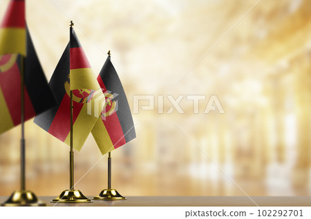 Small flags of the GDR on an abstract blurry background 102292701