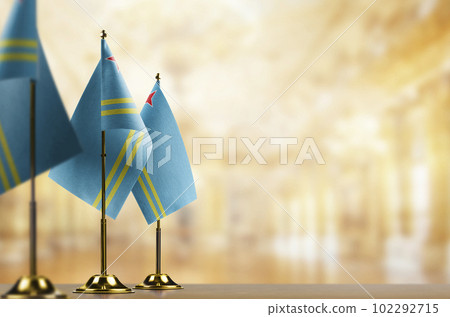 Small flags of the Aruba on an abstract blurry background 102292715