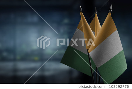 Small flags of the Cote dIvoire on an abstract blurry background 102292776