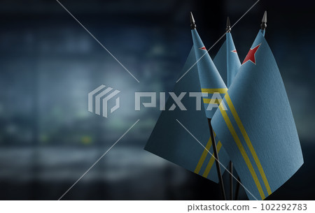 Small flags of the Aruba on an abstract blurry background 102292783