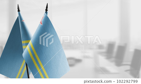 Small flags of the Aruba on an abstract blurry background 102292799