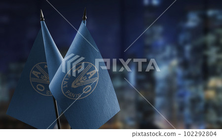 Small flags of the Food and agriculture organization on an abstract blurry background Small flags of the Food and agriculture organization on an abstract blurry background 102292804
