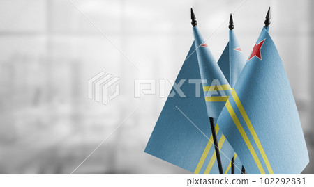 Small flags of the Aruba on an abstract blurry background 102292831