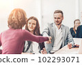 young businessman shaking hands with his business partner 102293071