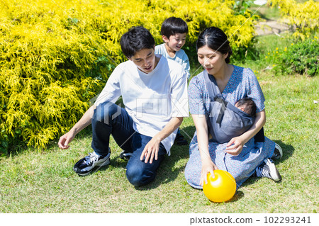 Child playing ball with family in park Child playing ball with family in park 102293241