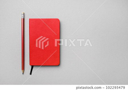 Red notebook, pencil 102293479