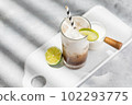 Trendy authentic dirty soda cocktail with cola, lime juice and cream in the kitchen table, top view 102293775