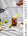 Prepairing authentic dirty soda cocktail with lime juice and cream in the kitchen table 102293777