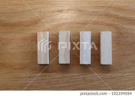 Four wooden puzzles arranged in a row. 102294094