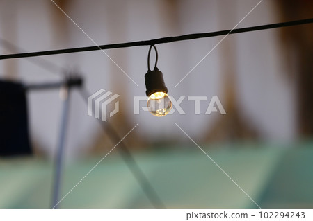 A light bulb hanging on the railing. A light bulb hanging on the railing. 102294243