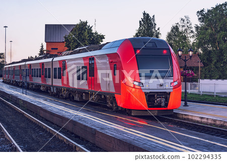 Train moves fast at sunrise time. 102294335