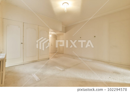 an empty room with white walls and no one person standing in the doorways on the right hand side, 102294578