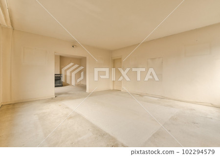 an empty room with white walls and no one person standing in the corner, or someone's house is on the other side 102294579