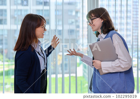 Meeting, conversation of female teacher and girl college student in educational center 102295019