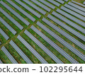 A close-up of solar panels in slow motion, as a gentle breeze ruffles their surface. The delicate movement creates a sense of tranquility and calm, and a reminder of the beauty of the natural world. 102295644