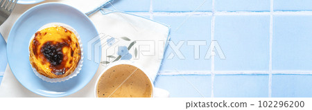 Traditional Portuguese dessert Pastel de nata on blue tile Traditional Portuguese dessert Pastel de nata on blue tile 102296200