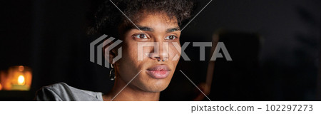 Portrait of handsome young guy using smartphone at night, sitting in dark room at home Portrait of handsome young guy using smartphone at night, sitting in dark room at home 102297273