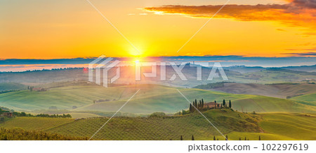 Tuscany landscape at spring foggy sunrise Tuscany landscape at spring foggy sunrise 102297619