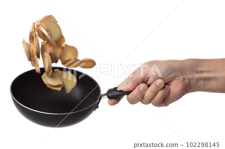Ginger fall fly in pan, fresh vegetable spice ginger falling. Organic fresh herbal ginger root head cut chop slice, close up texture. White background isolated freeze motion high speed shutter 102298145