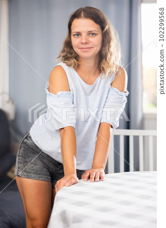 Young adult woman posing in living room Young adult woman posing in living room 102299568
