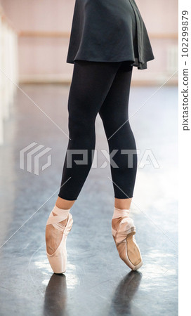 Close-up but ballerinas in pointe shoes in a dance class.  102299879