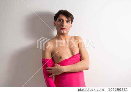 Homosexual in a pink female dress. A man in make-up. Homosexual in a pink female dress. A man in make-up. 102299881