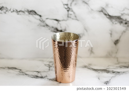 Copper tumbler and marble background 102301549