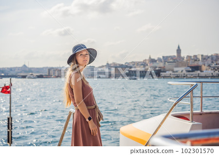 Portrait of beautiful woman tourist with view of Galata tower in Beyoglu, Istanbul, Turkey. Turkiye 102301570