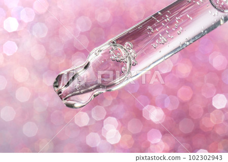 A drop of cosmetic oil falls from the pipette 102302943