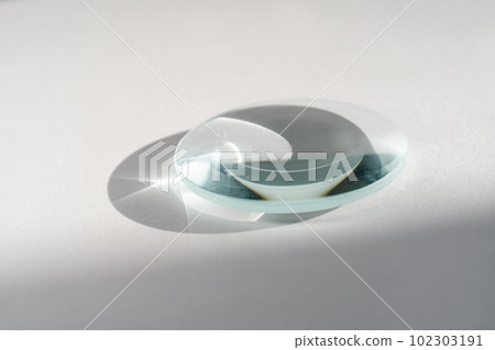 Transparent crystal lens on a white background. 102303191