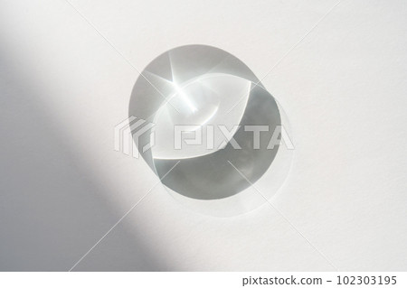 Transparent crystal lens on a white background. 102303195