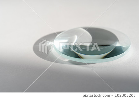 Transparent crystal lens on a white background. 102303205