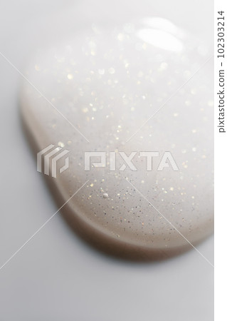 A drop of cosmetic product on a white background. A drop of cosmetic product on a white background. 102303214