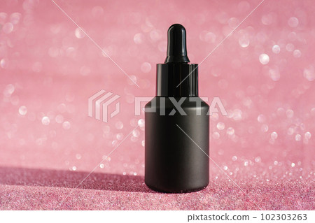 Black cosmetic bottles on a shining party background. Black cosmetic bottles on a shining party background. 102303263