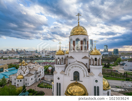 Summer Yekaterinburg and Temple on Blood in cloudy sunset. Aerial view of Yekaterinburg, Russia. Translation of the text on the temple 102303624