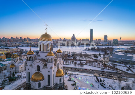 Winter Yekaterinburg and Temple on Blood in beautiful blue clear sunset. Aerial view of Yekaterinburg, Russia. Translation of the text on the temple Winter Yekaterinburg and Temple on Blood in beautiful blue clear sunset. Aerial view of Yekaterinburg, Russia. Translation of the text on the temple 102303629